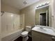Standard bathroom featuring a shower-tub combo and a single sink vanity with decorative accents at 99 Ashtonbrook Dr, Mcdonough, GA 30252