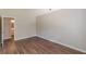 Bedroom with wood-look flooring and view into bathroom at 99 Ashtonbrook Dr, Mcdonough, GA 30252