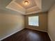 Bedroom features hardwood flooring and trey ceiling at 99 Ashtonbrook Dr, Mcdonough, GA 30252