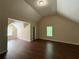 Large bedroom featuring vaulted ceilings, laminate flooring, and dual windows for ample natural light at 99 Ashtonbrook Dr, Mcdonough, GA 30252