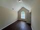 Bedroom featuring a vaulted ceiling, a single window, and dark wood-look laminate flooring at 99 Ashtonbrook Dr, Mcdonough, GA 30252