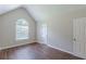 Bedroom with vaulted ceiling, arched window, and wood-look flooring at 99 Ashtonbrook Dr, Mcdonough, GA 30252