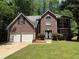 Traditional brick home with a two-car garage and a well-manicured lawn at 99 Ashtonbrook Dr, Mcdonough, GA 30252