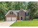 Traditional two-story brick home with a well-manicured lawn and an attached two-car garage at 99 Ashtonbrook Dr, Mcdonough, GA 30252