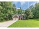 Brick two-story home with a two-car garage and mature landscaping, nestled among the trees at 99 Ashtonbrook Dr, Mcdonough, GA 30252
