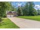 Traditional two-story brick home featuring a green lawn and mature trees in a peaceful setting at 99 Ashtonbrook Dr, Mcdonough, GA 30252