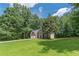 Traditional two-story home with manicured lawn, mature trees, and brick facade at 99 Ashtonbrook Dr, Mcdonough, GA 30252