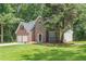 Traditional brick house featuring a green lawn and mature trees in a peaceful setting at 99 Ashtonbrook Dr, Mcdonough, GA 30252