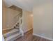 Foyer showcasing a staircase, neutral paint colors, and durable laminate floors at 99 Ashtonbrook Dr, Mcdonough, GA 30252