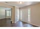Inviting foyer with hardwood floors, and white trim, leading to additional rooms and natural light at 99 Ashtonbrook Dr, Mcdonough, GA 30252