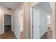 Hallway showcases doors to the bathroom and bedrooms with hard surface floors and neutral paint at 99 Ashtonbrook Dr, Mcdonough, GA 30252