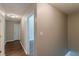 A hallway with wood-look flooring leading to various rooms with neutral paint and white doors at 99 Ashtonbrook Dr, Mcdonough, GA 30252