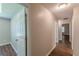 Bright hallway featuring hard surface floors and white doors leading to various rooms at 99 Ashtonbrook Dr, Mcdonough, GA 30252