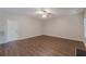 Open living room with wood-look flooring, a ceiling fan, and natural light from the window at 99 Ashtonbrook Dr, Mcdonough, GA 30252