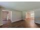 Open-concept living area with new wood-look flooring and staircase access at 99 Ashtonbrook Dr, Mcdonough, GA 30252