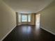 Bright living room featuring hardwood floors and a large bay window at 99 Ashtonbrook Dr, Mcdonough, GA 30252