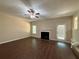 Living room with fireplace, ceiling fan, and hardwood flooring at 99 Ashtonbrook Dr, Mcdonough, GA 30252
