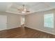 An airy main bedroom features tray ceilings, a fan, and natural lighting from the window at 99 Ashtonbrook Dr, Mcdonough, GA 30252