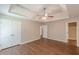 Large main bedroom with double closets, tray ceiling, ceiling fan, and ensuite bathroom entrance at 99 Ashtonbrook Dr, Mcdonough, GA 30252