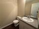 Powder room featuring granite countertop vanity and white toilet at 99 Ashtonbrook Dr, Mcdonough, GA 30252