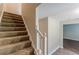 Carpeted stairs with a white railing lead to the upper level of the home at 99 Ashtonbrook Dr, Mcdonough, GA 30252