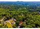 Aerial view of a wooded property, highlighting its location and natural surroundings with mountain view in the distance at 3290 Custer Lake Nw Dr, Marietta, GA 30064