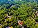 Stunning aerial view of a home nestled among mature trees, near a river, offering a private and serene setting at 3290 Custer Lake Nw Dr, Marietta, GA 30064