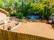 Spacious backyard with mature trees, shed, raised garden beds, and a charming fence at 3290 Custer Lake Nw Dr, Marietta, GA 30064