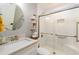 This bathroom has a white vanity with a sink and mirror and a shower with a glass door and white tiles at 3290 Custer Lake Nw Dr, Marietta, GA 30064