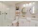 Bright bathroom features a white double vanity, round mirrors, and a glass enclosed shower with white subway tile at 3290 Custer Lake Nw Dr, Marietta, GA 30064