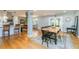 Open-concept dining room featuring hardwood floors, large table, and bright, neutral walls at 3290 Custer Lake Nw Dr, Marietta, GA 30064