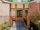 Inviting front entrance with brick surround, iron gate, and well-maintained landscaping at 3290 Custer Lake Nw Dr, Marietta, GA 30064