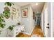 Hallway with decorative mirrors, a white console table, hardwood floors, and muted green paint at 3290 Custer Lake Nw Dr, Marietta, GA 30064