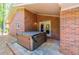 Back patio features a luxurious hot tub for relaxation and entertainment by the house's brick exterior at 3290 Custer Lake Nw Dr, Marietta, GA 30064