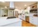 Bright, modern kitchen with stainless steel appliances, white cabinets, and farmhouse sink at 3290 Custer Lake Nw Dr, Marietta, GA 30064