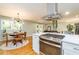 Open kitchen layout featuring stainless steel oven hood, island cooktop, and adjacent dining space at 3290 Custer Lake Nw Dr, Marietta, GA 30064