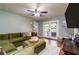 Comfortable living room featuring an plush green couch, hardwood floors, and a walkout patio at 3290 Custer Lake Nw Dr, Marietta, GA 30064