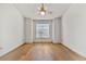 Bright, spacious bedroom with hardwood floors, ceiling fan, and large window at 406 Vinings Forest Se Cir, Smyrna, GA 30080