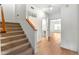 Entryway with carpeted stairs, hardwood floors, and an open doorway to another room at 406 Vinings Forest Se Cir, Smyrna, GA 30080