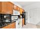 Kitchen features a refrigerator, stove, microwave, cabinets, and black tile countertops at 406 Vinings Forest Se Cir, Smyrna, GA 30080