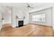 Bright living room with hardwood floors, fireplace, ceiling fan and a large window at 406 Vinings Forest Se Cir, Smyrna, GA 30080