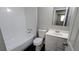 This bathroom is all-white with a tub and shower combination at 5266 Long Green Ln, Stone Mountain, GA 30088
