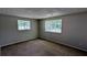 Serene bedroom with neutral walls, soft carpet, and windows providing natural light, creating a cozy retreat at 5266 Long Green Ln, Stone Mountain, GA 30088