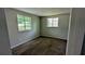This gray carpeted bedroom is lit by two windows at 5266 Long Green Ln, Stone Mountain, GA 30088