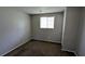 A modest gray carpeted bedroom with a window and closet at 5266 Long Green Ln, Stone Mountain, GA 30088