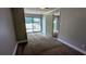 A gray carpeted bedroom with sliding glass doors to the backyard at 5266 Long Green Ln, Stone Mountain, GA 30088