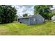 Home's exterior with blue siding sits on a lush green lawn at 5266 Long Green Ln, Stone Mountain, GA 30088