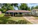 Charming single-story home featuring a well-manicured lawn, blue siding, and an inviting covered front porch at 5266 Long Green Ln, Stone Mountain, GA 30088