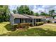 Charming single-story home with blue siding, a well-maintained lawn, and a cozy covered front porch at 5266 Long Green Ln, Stone Mountain, GA 30088