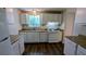Bright kitchen featuring white cabinetry, laminate countertops, and modern appliances, ideal for cooking at 5266 Long Green Ln, Stone Mountain, GA 30088